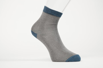Transparent foot with a sock. Advertising of the product on the white background.