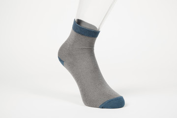 Transparent foot with a sock. Advertising of the product on the white background.
