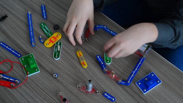 Child conducts physical experiments with light on designer