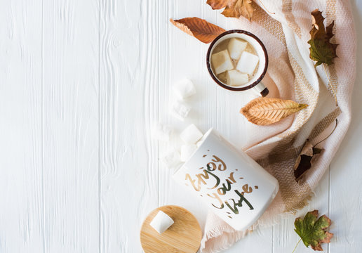 Fall still life with yellow leaves, coffe with marshmallows and 