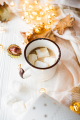 Fall still life with yellow leaves, coffe with marshmallows and 