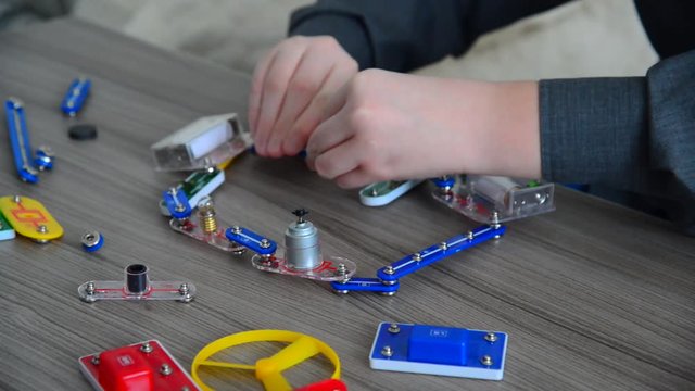 Child conducts physical experiments with light and movement on designer