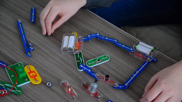 Child tries to conducts physical experiments on designer