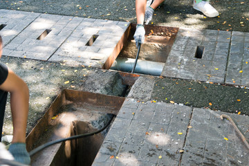worker wiring network cable pass through hold underground from manhold