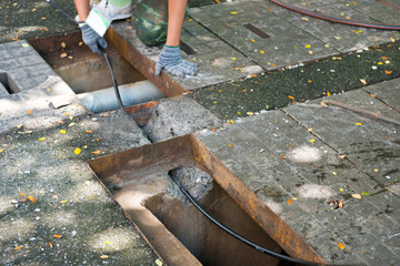 worker wiring network cable pass through hold underground from manhold