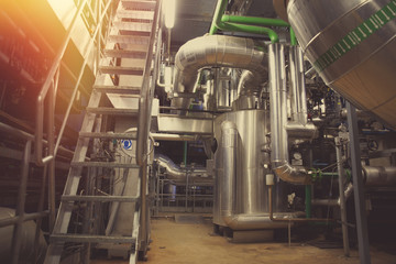 Equipment, cables and piping as found inside of a modern industrial power plant