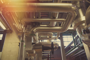 Equipment, cables and piping as found inside of a modern industrial power plant
