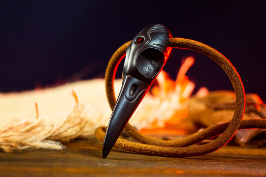 Closeup wooden raven skull as a magic amulet for witchcraft.
