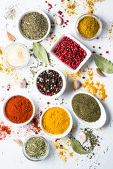 Set of spices in a bowls on white background. Top view