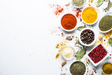 Set of spices in a bowls on white background. Top view copy space.