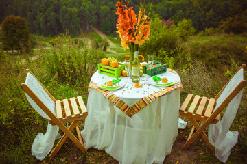 Eclairs on dinner plates decorated with green and orange sweets