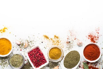 Poster Various spices in a bowls on white background. Top view copy space. © nadianb
