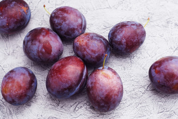 fresh plums on wooden table