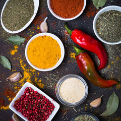 Various spices in a bowls on stone table.