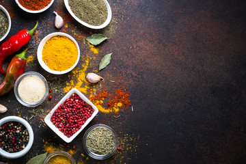Various spices in a bowls on stone table. Top view with copy space.