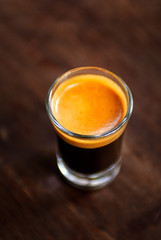 A cup of espresso shot coffee on wooden table background with blank copy space