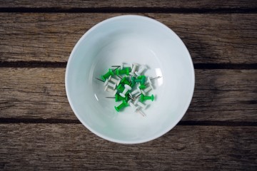 Overhead view of paper pins in bowl