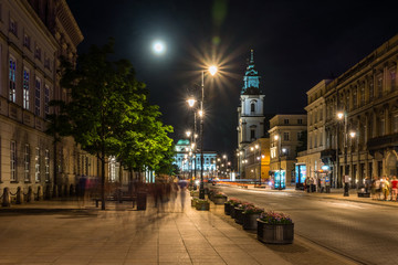 Fototapeta na wymiar Church of the Holy Cross on Krakowskie Przedmiescie street at night in Warsaw, Poland