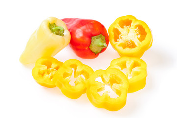 Fresh red, yellow bulgarian pepper, with slices of sweet pepper. On white background