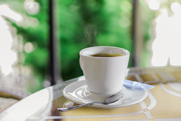 cup of coffee on a table in a cafe on a blurry background
