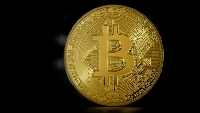 Rotating Bitcoin. Spin a coin. Close-up shot.
