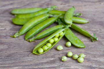 Green peas on wooden background