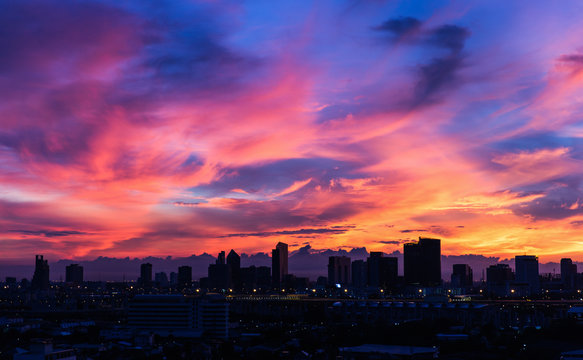 Dark City Covered By Dramatic Colorful Morning Sky With Moving Clouds Before Sunrise After Storm At Night