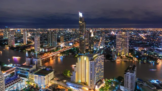 Aerial Bangkok Night Cityscape Riverside Chao Phraya River Of Thailand 4K Time Lapse (pan right)