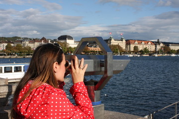 Fototapeta na wymiar Woman waching a landmarks od Zurich in Swiss.