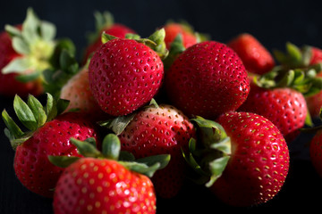 Strawberries on the dark wooden surface