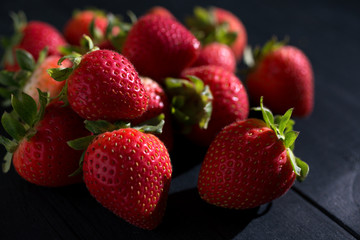 Strawberries on the dark wooden surface