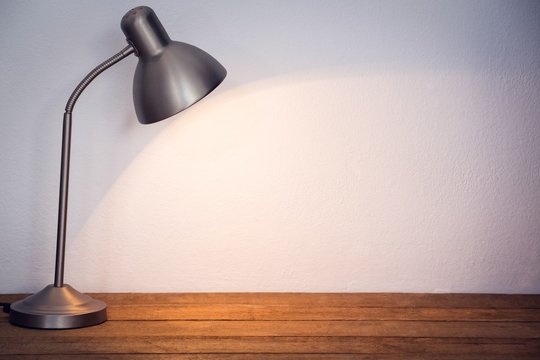 Illuminated table lamp by wall