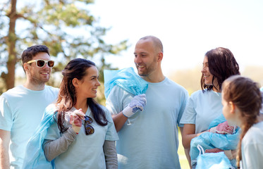 volunteers with garbage bags walking outdoors