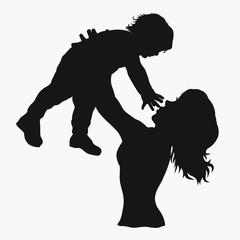 Silhouette of mother playing with baby