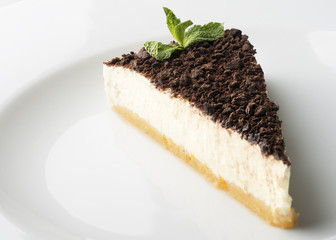 Cheese cake with chocolate on top in a shallow depth of field