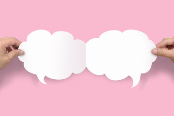 Two hands holding up speech bubbles
