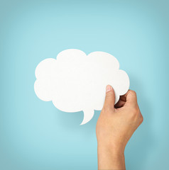 Hand holding an empty speech bubble