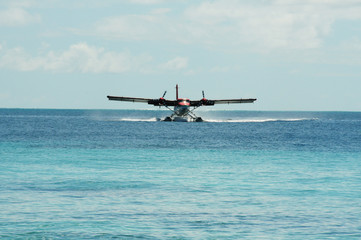 Front on View of Sea Plane taking landing on the blue crystal waters of the indian ocean