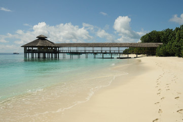 Wooden Pier leading out into the ocean, floating restaurant