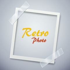 Retro photo frame attached with adhesive tape. Sweet memories concept.