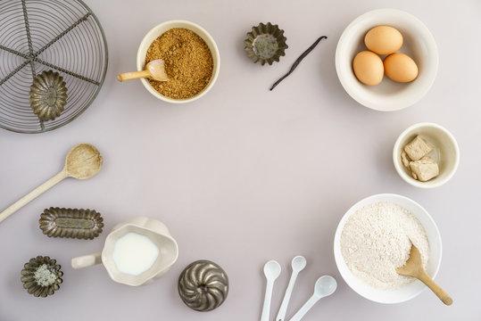 Flatlay collection of tools and ingredients for home baking on light grey background with copyspace in the center shot from above © Elisabeth Cölfen