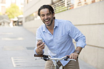 young happy man smiling using mobile phone on vintage cool retro bike