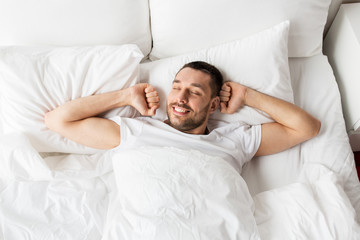 man lying in bed at home