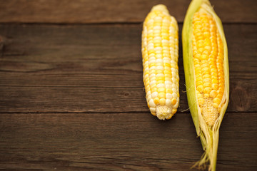 Corn corn on wooden texture. Space for text. Harvest.