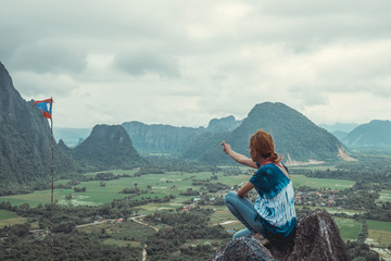 Hipster girl A bright teen enjoy top view mountain. Tourist traveler on background landscape view.