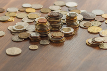 Different gold and silver collector's coins on the wooden table