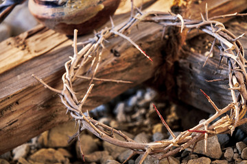 Bloodstained crown of thorns on a wooden cross