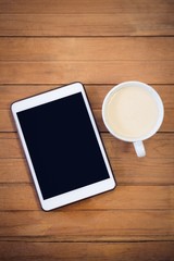 Overhead view of digital tablet with coffee cup