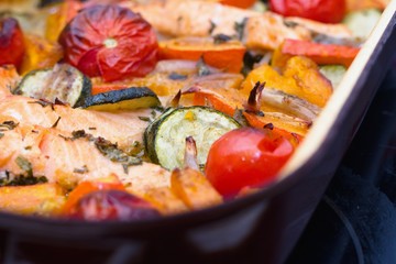Homemade roasted salmon and vegetables in a baking tray