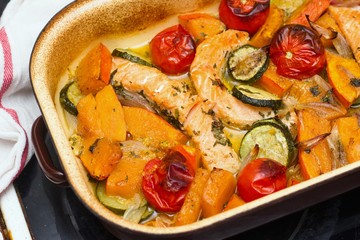 Homemade roasted salmon and vegetables in a baking tray